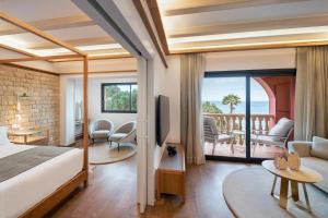 a hotel room with a bed and a balcony at Hotel Cala del Pi - Adults Only in Platja d'Aro +117 photos