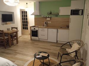 a kitchen with a table and chairs in a room at Coin Tendresse in Cézac