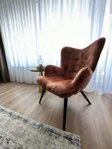 a chair sitting in a room with a window at Aspire Palais Recklinghausen, Trademark Collection by Wyndham in Recklinghausen