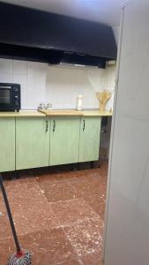 a kitchen with a mop in the middle of a room at Apartamento Nora in Iznate