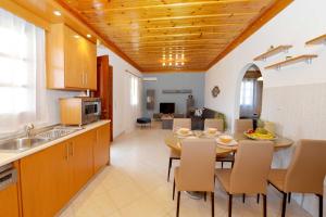 a kitchen and dining room with a table and chairs at Captain Ilias House Chalki in Halki