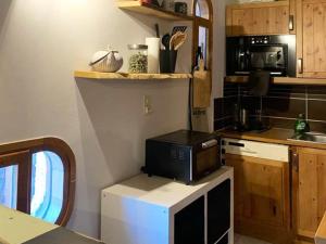 eine Küche mit einer Mikrowelle auf dem Kühlschrank in der Unterkunft Appartement Les Orres, 2 pièces, 6 personnes - FR-1-322-197 in Les Orres