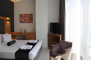 a hotel room with a bed and a chair at Vplus hotel atasehir in Istanbul