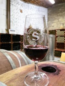 a glass of wine sitting on top of a table at Winnica Nad Jarem in Sandomierz