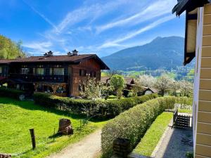 a house on a hill next to a river at Ferienwohnung Alpenherz Berchtesgaden in Berchtesgaden