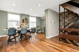 a dining room with a table and chairs at Luxurious & Spacious Townhouse in London