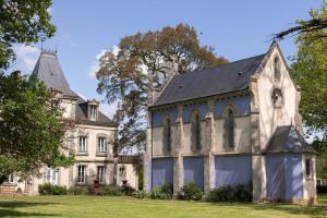 un viejo edificio con un reloj a un lado. en CHATEAU DE LA RICHERIE, en Beaurepaire