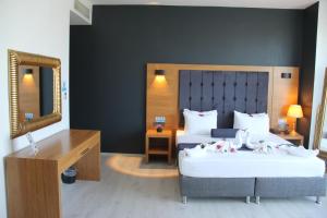 a hotel room with two beds and a mirror at Vplus hotel atasehir in Istanbul