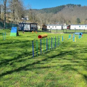 a park with a bunch of play equipment in the grass at Camping Vallee de l'Our in Untereisenbach