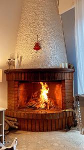 a fire in a brick fireplace in a room at Family House in Santa Severa