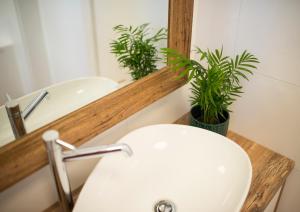 a bathroom with a white sink and a mirror at Apartament Wiśniewski - nad Jeziorem Drwęckim in Ostróda +35 photos