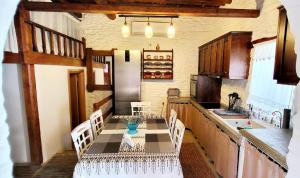 a kitchen with a table and chairs in a kitchen at Mannashouse in Émbonas