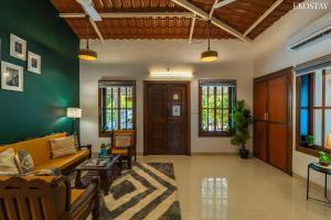 a living room with green walls and a couch at EKO STAY- CASA POLO Villa in Alibaug