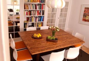 a dining room with a wooden table and chairs at Haus Koenige Hinterzarten in Hinterzarten