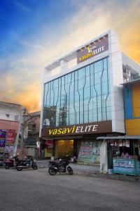 a building with motorcycles parked in front of it at HOTEL VASAVI ELITE in Bāpatla