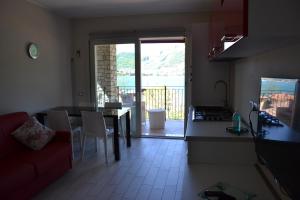 a kitchen and living room with a table and a couch at Dolce Casa Lago in Paratico +7 photos