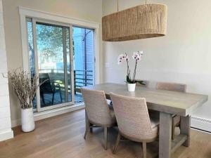a dining room with a table and chairs and a window at Luxury Water-View West End Condo in Provincetown +19 photos