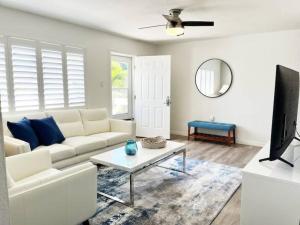a living room with a white couch and a table at Modern Apartment - 3 of 4 in Punta Gorda