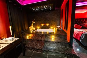 a bathroom with a bath tub with candles in it at Suite Romantique in Narbonne