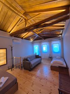 a living room with blue lights on the ceilings at Ελιά Ξενώνας / Elia Xenonas in Mytilene
