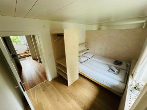 a small room with a bed and a closet at Chalet Franzi - Ruhiges Chalet mit Bergblick, Garten und gratis Eintritt ins Solarbad in Dorfgastein