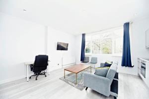 a living room with a couch and a table at Chic 1BR Thornton Flat - Charm and City Access in Thornton Heath
