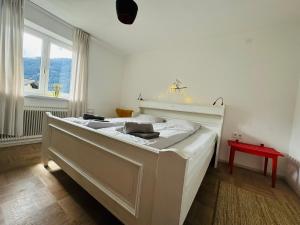 a white bed in a room with a window at Chalet Franzi - gleich an der Piste im Gasteinertal in Dorfgastein +65 photos