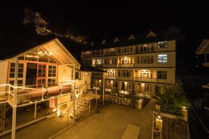 an aerial view of a building at night at The Village Manali-TVM, "Bunrise" Cafe, "Old Town Tavern" Pub in Manāli