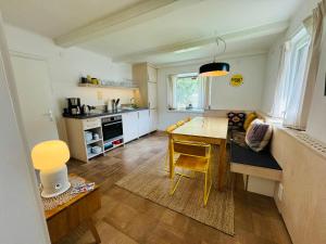 a kitchen with a table and a dining room at Chalet Franzi - Ruhiges Chalet mit Bergblick, Garten und gratis Eintritt ins Solarbad in Dorfgastein