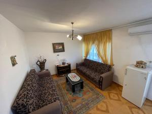 a living room with a couch and a table at Brami Apartment in Berat