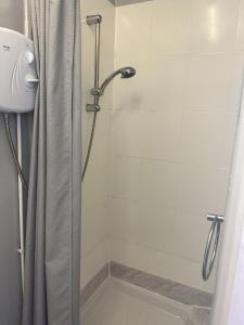 a shower with a shower curtain in a bathroom at The Majestic in Great Yarmouth