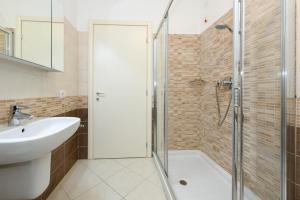 a bathroom with a shower and a sink at Madeleine in Toscolano Maderno +17 photos