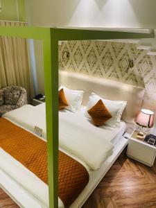 łóżko z zieloną ramą w pokoju w obiekcie Victorian Elegance Luxury Stays w mieście Amritsar