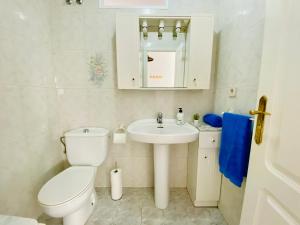 Un baño blanco con inodoro y lavabo. en Sunny Penthouse close to everything, en Torrevieja 14 fotos más