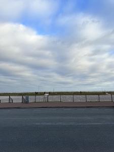 a fence on the side of a road next to a street at The Majestic in Great Yarmouth