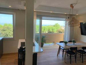 Un comedor y una sala de estar con mesa y sillas. en Appartamento Fronte Mare Sottomarina, en Sottomarina