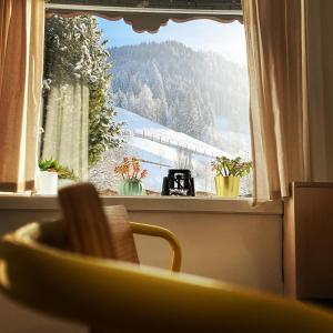 a window with a view of a snow covered mountain at Chalet Franzi in Dorfgastein