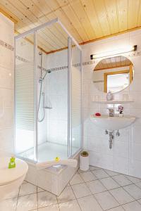 a bathroom with a shower and a sink at Pension Karner in Mittenwald