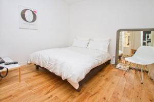 a bedroom with a bed and a table and a chair at Paris Les Halles in Paris