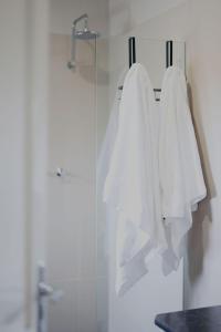 two white towels hanging on a rack in a bathroom at The Customs House Port MacDonnell in Port MacDonnell