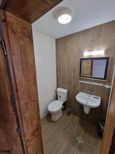 a bathroom with a toilet and a sink at Престиж in Arbanasi