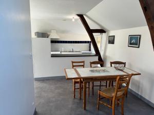 - une salle à manger avec une table et des chaises dans l'établissement calme et verdure, à La Bazouge-de-Chemeré
