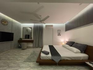 a bedroom with a bed with a ceiling fan at Cozy 2-Bed Portion at Gulshan Iqbal blk 7 in Karachi
