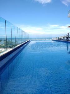a large swimming pool on top of a building at AC Hotel By Marriott Santa Marta in Santa Marta