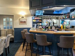 a bar with bar stools in a restaurant at The Boatside Inn - North Tyne - 2 Bedroom Cottage in Hexham