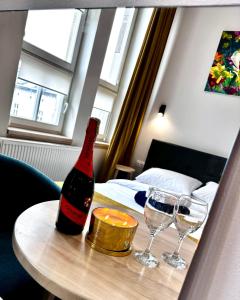 a bottle of wine on a table with two wine glasses at HotelGallery 21 in Lviv