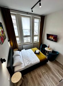 a bedroom with a bed and two windows at HotelGallery 21 in Lviv