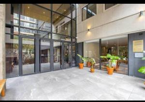 a large building with potted plants in front of it at Blackbrick Sandton Two private owned in Johannesburg