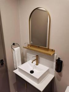 a white bathroom with a sink and a mirror at Blackbrick Sandton Two private owned in Johannesburg