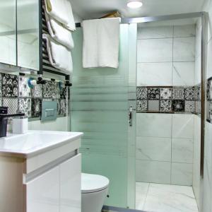 a bathroom with a toilet and a shower at Denis suit apart in Istanbul